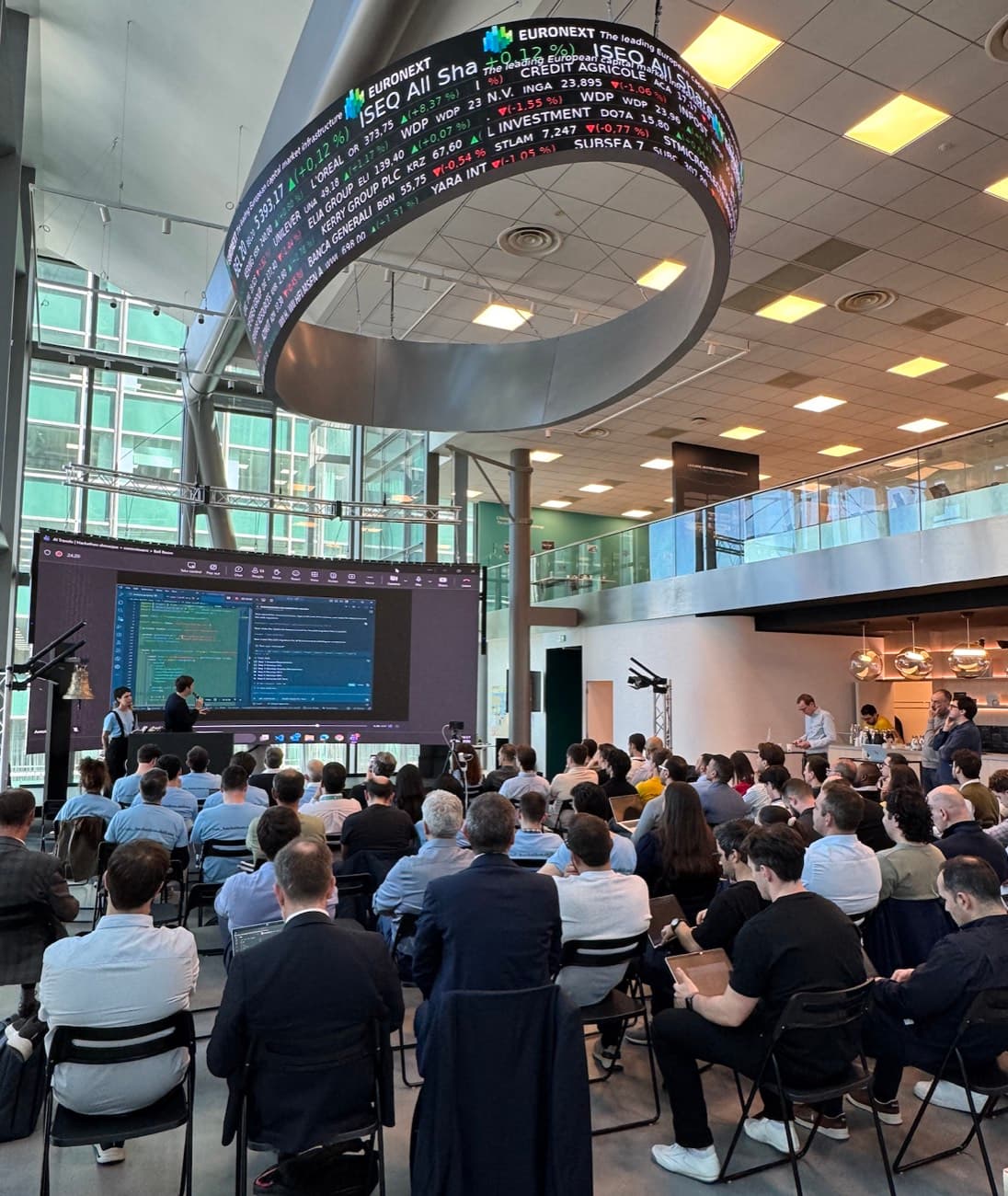 The Euronext hackathon floor, live coding on the main screen